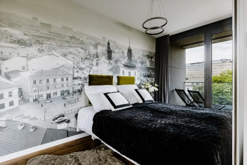 Modern bedroom with a city-view mural at Art Residence in Lublin, Poland.