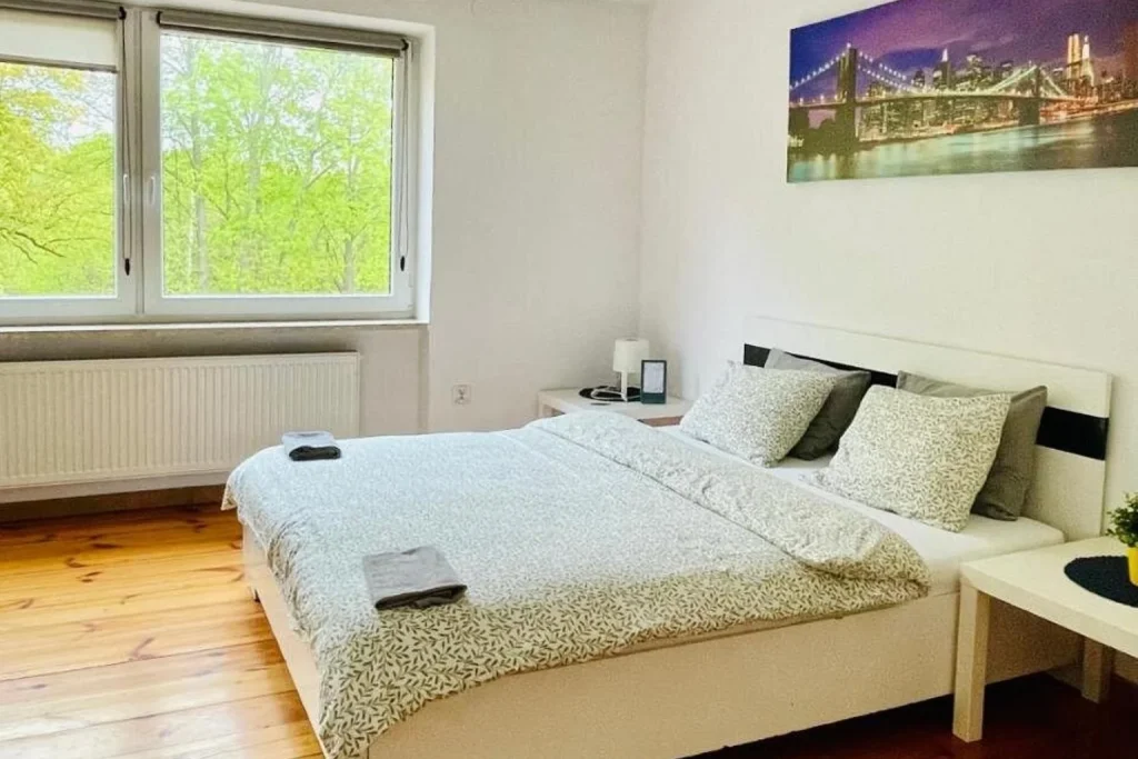 Double room with wooden floor and large window at BC Group Hostel in Lublin