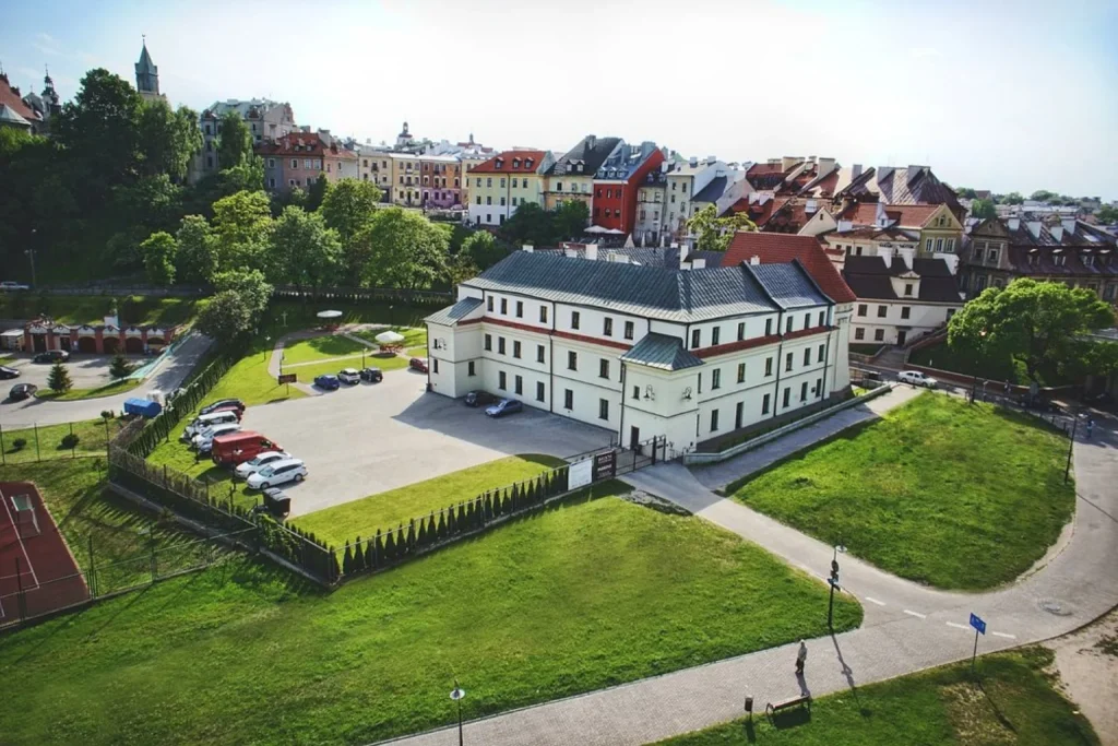 Exterior of Dom Na Podwalu in Lublin with the historic Old Town buildings in the background