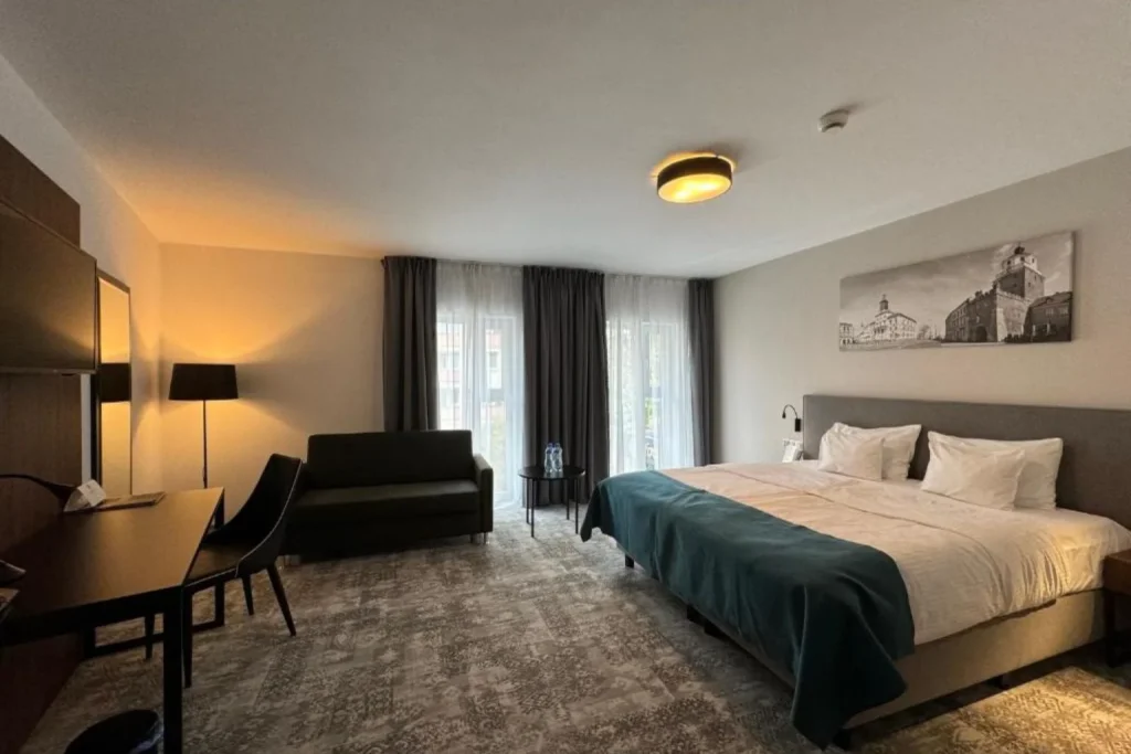 Superior room with a seating area at Focus Hotel Premium Lublin in Lublin, Poland.