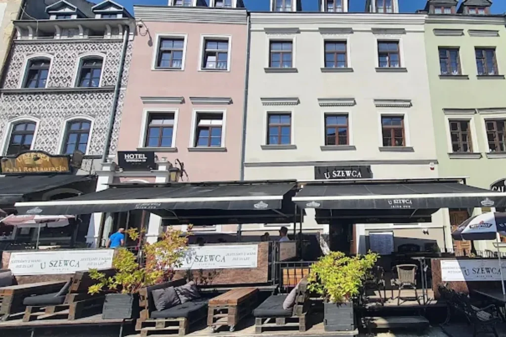 Exterior of Hotel Grodzka 20 in Lublin with outdoor restaurant seating in the Old Town