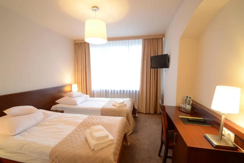 Twin room with two single beds and a work desk at Hotel PZMot in Lublin