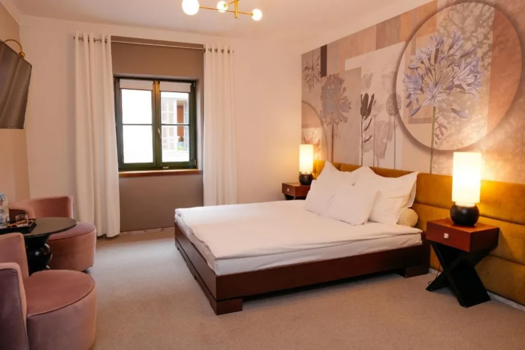 Deluxe double room with floral wall art at Vanilla Hotel in Lublin, Poland.