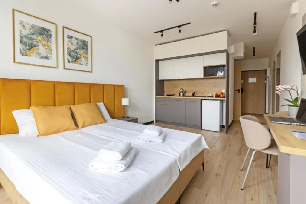 Modern studio with double bed, kitchenette and work desk at Zeus Apartments in Lublin